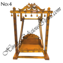 A wooden swing with peacock designs, handcrafted and intended for home use.