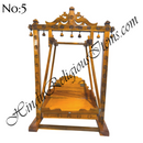 A wooden swing with peacock designs, handcrafted and intended for home use.