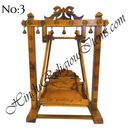 A wooden swing with peacock designs, handcrafted and intended for home use.