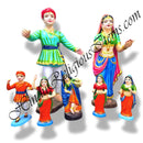 A collection of colorful fiber statues depicting various characters, primarily in traditional Indian attire, with some in dynamic poses.