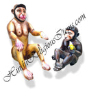 Two fiber statues of monkeys, one sitting and the other sitting down, with a website address visible in the background.