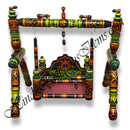 A colorful wooden palna (cradle) with intricate patterns and decorative elements, primarily used as a baby cradle.