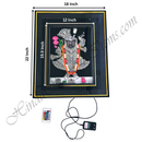 Framed artwork of a deity with dimensions and remote control on a white background