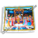 A satin printed pichwai (backdrop) featuring a depiction of a hindola (swing) ceremony with multiple characters in a garden setting, bordered with a blue pattern.