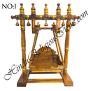 A wooden hindola (swing) with handcrafted woodwork, featuring a detachable seat, in a natural wood color.