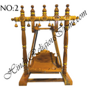 A wooden hindola (swing) with handcrafted woodwork, featuring a detachable seat, in a natural wood color.