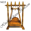 A wooden hindola (swing) with handcrafted woodwork, featuring a detachable seat, in a natural wood color.