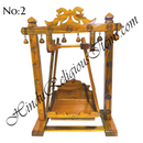 A wooden swing with peacock designs, handcrafted and intended for home use.